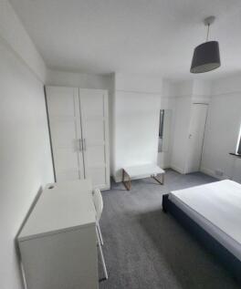 Bright and airy bedroom featuring a comfortable...