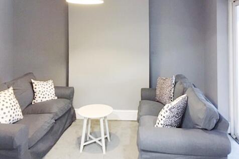 Neat contemporary living room with two matching...