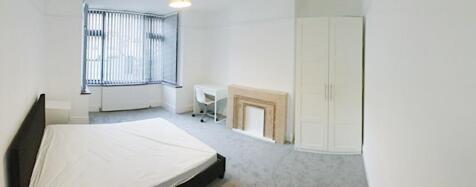 Bright, spacious bedroom with a large bay windo...
