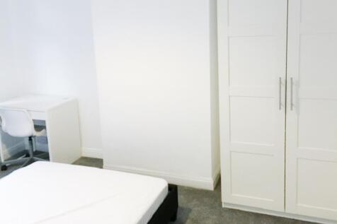 Bright, clean bedroom with neutral decor, a war...