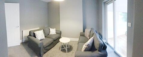 Bright, modern living room with two comfortable...