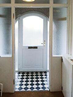 Bright and welcoming entrance with a white fron...