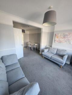 A bright and welcoming living room with comfort...