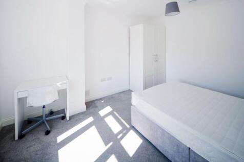 Bright, minimalist double bedroom with a large ...