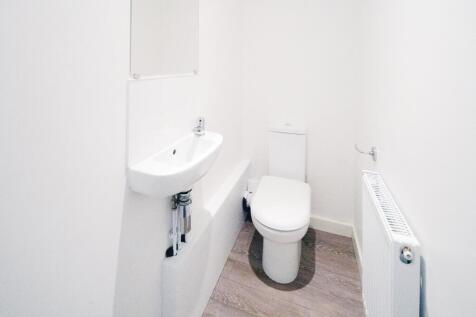 Bright, modern WC with clean white fixtures, a ...