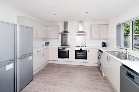 Bright modern kitchen with dual ovens, stainles...