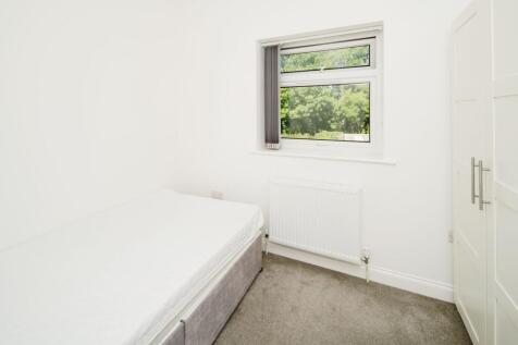 Bright, freshly decorated bedroom with a comfor...