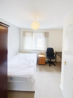 Bright, simply furnished double bedroom with a ...