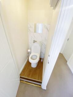 Bright, freshly renovated WC with modern white ...