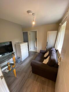 A cozy living room featuring a comfortable sofa...