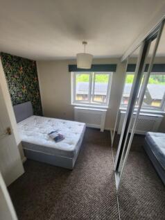 Bright and inviting double bedroom with natural...