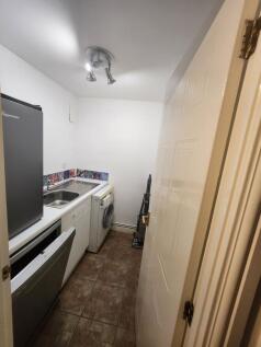 A compact kitchen area featuring a small sink, ...