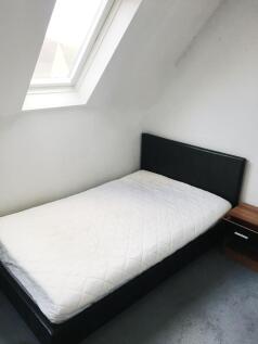 Bright, neatly presented bedroom with a comfort...