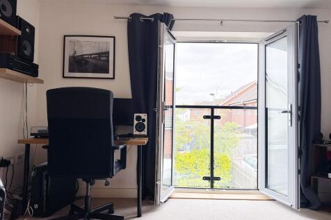 Bright upstairs bedroom with a study area besid...