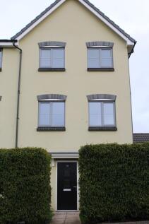 A welcoming front view of a modern, yellow resi...