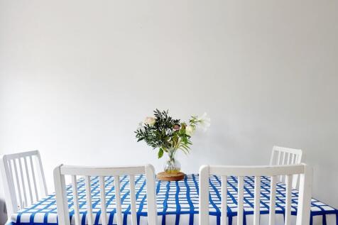 Bright, minimalist dining area with a patterned...