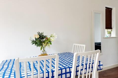 Bright, minimalist dining area with a patterned...