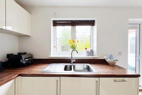 Bright modern kitchen with a double stainless-s...