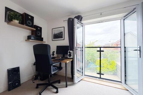 Bright, modern bedroom with a study corner and ...