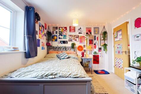Bright, stylish double bedroom with a made bed,...