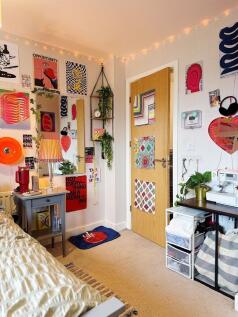 Bright, colorful bedroom with decorative wall a...