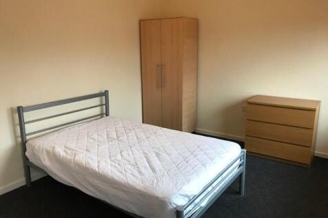 A clean and simply furnished double bedroom fea...
