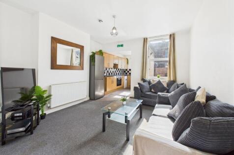 A bright and spacious living room with a large ...