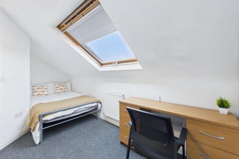 Bright and welcoming bedroom featuring a single...