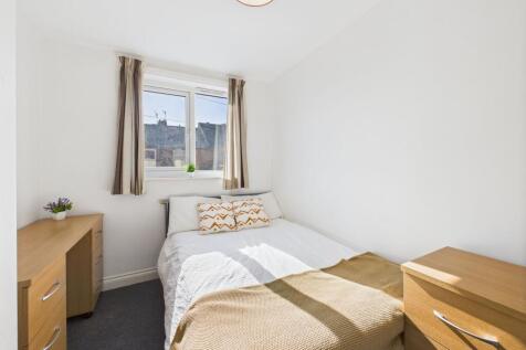 Bright and airy bedroom featuring a double bed ...