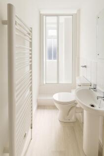 Bright and clean bathroom featuring a modern to...