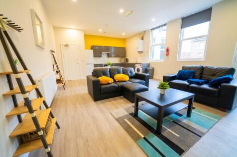 A spacious and well-lit contemporary living roo...