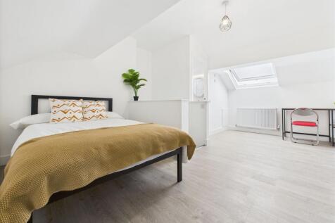 Bright and modern bedroom featuring a comfortab...