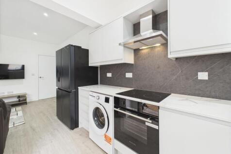 Modern and bright kitchen featuring sleek white...