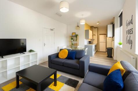 Bright and stylish living room featuring comfor...