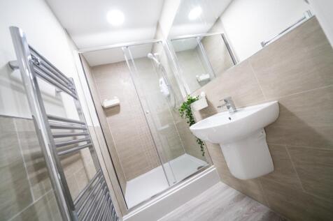 Bright and modern bathroom featuring a spacious...