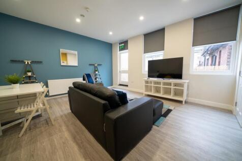 Bright and modern living room featuring a large...