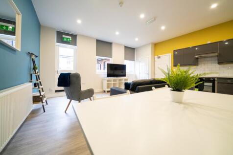 Bright and modern living room featuring large w...