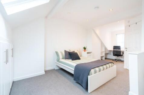 Bright and airy bedroom with a comfortable doub...