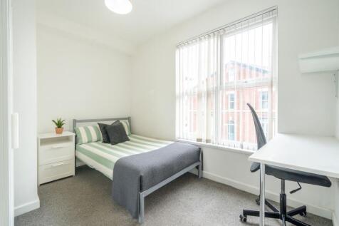 Bright and inviting bedroom featuring a fresh, ...