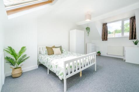 Bright and airy bedroom featuring a cozy double...