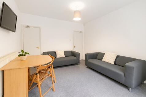 Bright and spacious living room featuring two m...