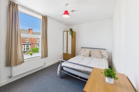 Bright and inviting bedroom featuring a comfort...