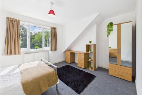 Bright and welcoming bedroom with large window ...