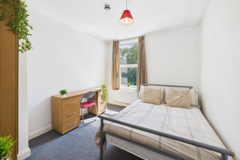 Bright and welcoming bedroom with a comfortable...