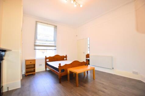 A bright, tidy bedroom featuring a wooden doubl...