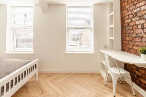 Bright and inviting bedroom with ample natural ...