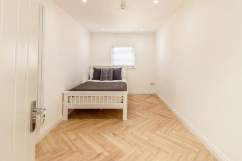 A bright, welcoming double bedroom featuring a ...