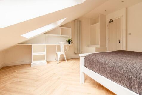Bright and airy bedroom featuring a comfortable...