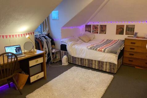 A cozy bedroom with ample space for relaxation ...