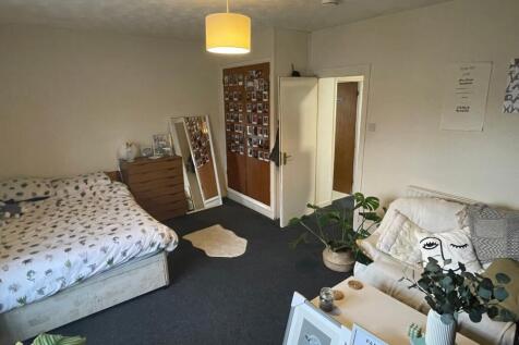 A spacious and inviting double bedroom with amp...